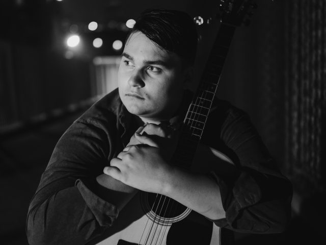 Michael DeLano and guitar at night.